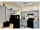 Kitchen with gray cabinets, black appliances and light colored countertop at 10489 S 182Nd Dr, Goodyear, AZ 85338