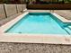 Private backyard swimming pool with a Baja step in low-maintenance landscaping at 10489 S 182Nd Dr, Goodyear, AZ 85338