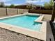 Private backyard swimming pool with a Baja step is ready for entertaining and relaxation at 10489 S 182Nd Dr, Goodyear, AZ 85338