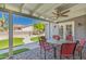 Relaxing covered patio with table and chairs offering views of the manicured backyard at 1060 S Florence Dr, Mesa, AZ 85208