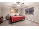 Cozy bedroom with a ceiling fan, patterned window, and comfortable furnishings at 1060 S Florence Dr, Mesa, AZ 85208