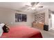 Bedroom featuring a decorative window, ceiling fan, and warm neutral tones at 1060 S Florence Dr, Mesa, AZ 85208
