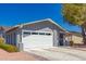Attached garage with a well-maintained driveway and desert landscaping at 1060 S Florence Dr, Mesa, AZ 85208