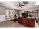 Spacious home office featuring wood floors, built-in bookshelves, and ample natural light from the bay window at 1060 S Florence Dr, Mesa, AZ 85208