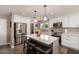 Bright kitchen showcasing a kitchen island, stainless steel appliances, and wood-look flooring at 1060 S Florence Dr, Mesa, AZ 85208