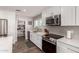 Modern kitchen featuring white cabinets, stainless steel appliances, and an open pantry at 1060 S Florence Dr, Mesa, AZ 85208