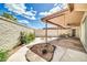 Backyard with a covered patio, desert landscaping features, concrete walkways, and a brick perimeter wall at 10601 W Hutton Dr, Sun City, AZ 85351