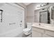Bathroom with a shower-tub combo, toilet, sink, and cabinet space, creating a functional layout at 10601 W Hutton Dr, Sun City, AZ 85351