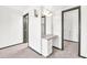 Carpeted bedroom with vanity and ensuite bathroom at 10601 W Hutton Dr, Sun City, AZ 85351