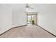 Bright bedroom with sliding doors to a patio and neutral carpet at 10601 W Hutton Dr, Sun City, AZ 85351