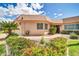 Inviting front exterior featuring lush landscaping and a well-maintained walkway leading to a cozy home at 10601 W Hutton Dr, Sun City, AZ 85351