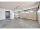Spacious garage featuring neutral-toned walls, bright lighting, and ample room for storage or parking at 10601 W Hutton Dr, Sun City, AZ 85351