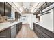 Galley kitchen offers ample storage and counter space, tile floors, and natural light at 10601 W Hutton Dr, Sun City, AZ 85351