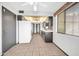 Functional kitchen with tile flooring, bright white appliances, and sleek countertops for culinary enthusiasts at 10601 W Hutton Dr, Sun City, AZ 85351