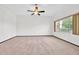 Open concept living room is filled with natural light and features neutral carpet at 10601 W Hutton Dr, Sun City, AZ 85351