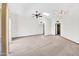 Bright living room with ceiling fan, skylight, and neutral carpet with access to other rooms at 10601 W Hutton Dr, Sun City, AZ 85351