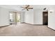 Bright living room with sliding glass doors to a patio and neutral carpet at 10601 W Hutton Dr, Sun City, AZ 85351
