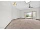 Open floor plan living area featuring a ceiling fan and slider access to the patio at 10601 W Hutton Dr, Sun City, AZ 85351