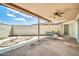 Covered patio area with a ceiling fan, seating, and a brick wall that provides privacy at 10601 W Hutton Dr, Sun City, AZ 85351