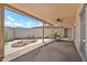 Covered patio featuring a ceiling fan, patio furniture, and desert landscaping, perfect for relaxing and entertaining guests at 10601 W Hutton Dr, Sun City, AZ 85351