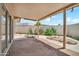 Covered patio area with concrete flooring, brick wall, and decorative landscaping creating a relaxing outdoor space at 10601 W Hutton Dr, Sun City, AZ 85351