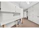 Bright workshop area with pegboard, cabinets, countertop work space, and carpeted storage area providing ample organizational space at 10601 W Hutton Dr, Sun City, AZ 85351