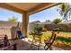 Inviting backyard featuring patio seating, lush green lawn, and a brick wall for privacy at 11591 W Jefferson St, Avondale, AZ 85323