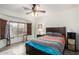 Inviting bedroom with neutral walls, ceiling fan and wooden window blinds at 11591 W Jefferson St, Avondale, AZ 85323
