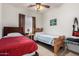 Bedroom with two beds, neutral walls, and carpeted floors with window at 11591 W Jefferson St, Avondale, AZ 85323