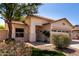 Charming single-story home with a well-manicured lawn, mature tree, and welcoming entrance at 11591 W Jefferson St, Avondale, AZ 85323