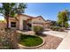 Inviting single-Gathering home with a lush front yard, decorative rock, and a concrete driveway at 11591 W Jefferson St, Avondale, AZ 85323