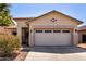 Attached two-car garage with decorative accents above, and a wide concrete driveway at 11591 W Jefferson St, Avondale, AZ 85323