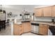 Bright kitchen area with stainless steel dishwasher, breakfast bar, and tile flooring at 11591 W Jefferson St, Avondale, AZ 85323