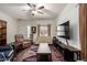 Cozy living room with a ceiling fan, large TV, and a decorative area rug at 11591 W Jefferson St, Avondale, AZ 85323
