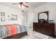 Spacious bedroom featuring a ceiling fan, neutral wall and wooden furniture at 11591 W Jefferson St, Avondale, AZ 85323