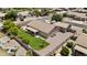 Aerial view of a well maintained backyard with lawn, covered patio, and manicured landscaping at 1182 E Canyon Way, Chandler, AZ 85249