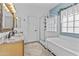 Bright bathroom featuring a glass-enclosed shower, soaking tub, and a vanity with marble countertops at 1182 E Canyon Way, Chandler, AZ 85249