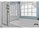 Clean bathroom with separate shower and tub with decorative glass block window at 1182 E Canyon Way, Chandler, AZ 85249