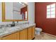 Bathroom with granite countertops, cabinet, shower and red accent wall at 1182 E Canyon Way, Chandler, AZ 85249
