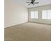 Bright bedroom with neutral carpet, ceiling fan, and two large windows with blinds at 1182 E Canyon Way, Chandler, AZ 85249