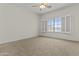 The spacious bedroom has plush carpet and a large window that let in natural light at 1182 E Canyon Way, Chandler, AZ 85249