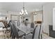 Dining room featuring an elegant chandelier and a glass-top dining table with upholstered chairs at 1182 E Canyon Way, Chandler, AZ 85249