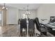 Formal dining area with modern chandelier, seating for eight, and home office at 1182 E Canyon Way, Chandler, AZ 85249