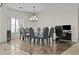 Elegant dining room featuring a glass table with seating for eight and a decorative chandelier at 1182 E Canyon Way, Chandler, AZ 85249