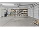 Spacious garage with high ceilings, storage shelving and door to the exterior at 1182 E Canyon Way, Chandler, AZ 85249