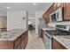 Modern kitchen with granite countertops, stainless steel appliances, and tiled floors at 1182 E Canyon Way, Chandler, AZ 85249
