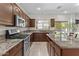 Modern kitchen with stainless steel appliances, granite countertops, and ample cabinet space at 1182 E Canyon Way, Chandler, AZ 85249