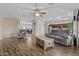 Open-concept living room with hardwood floors and a direct view of the dining room at 1182 E Canyon Way, Chandler, AZ 85249