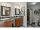 Bathroom with dual sinks, framed mirrors, and glass block window adding a touch of elegance at 12154 S Ki Rd, Phoenix, AZ 85044