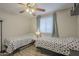 Bedroom features ceiling fan and twin beds covered with polka dot covers at 12154 S Ki Rd, Phoenix, AZ 85044